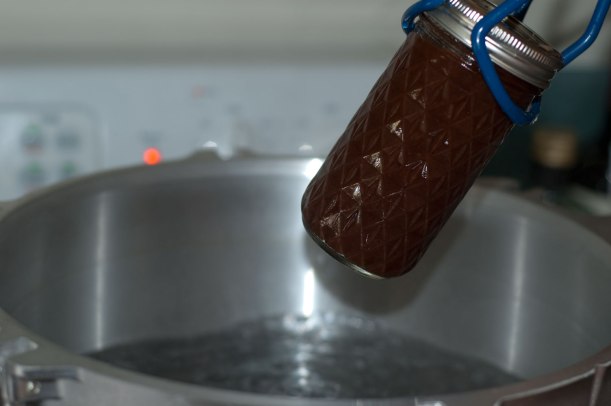 Here's a jar of apple butter coming out of the pot after processing. 