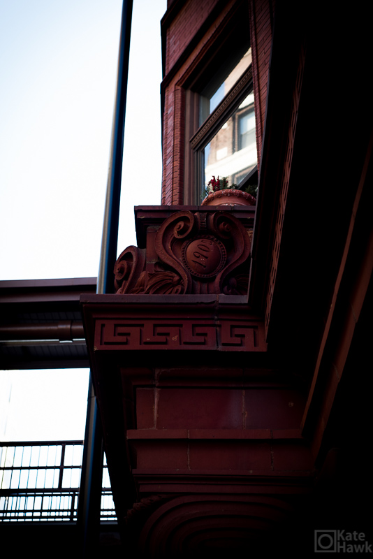 A picture of the exterior of a building on Plum Street with the year 1905 impressed in the decorative brick work.